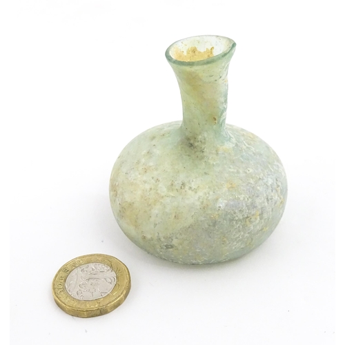 265 - A Roman glass flask with globular body and flared rim. Approx. 2 1/2