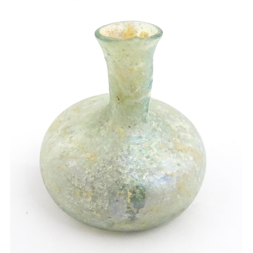 265 - A Roman glass flask with globular body and flared rim. Approx. 2 1/2