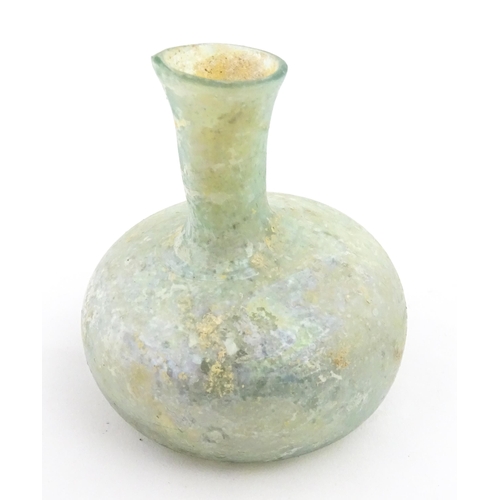 265 - A Roman glass flask with globular body and flared rim. Approx. 2 1/2