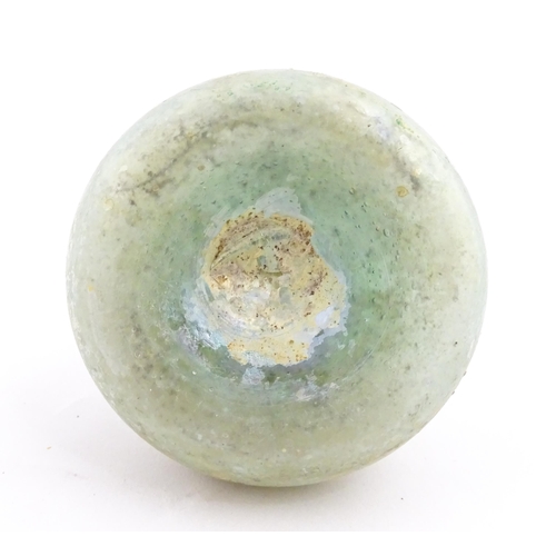 265 - A Roman glass flask with globular body and flared rim. Approx. 2 1/2