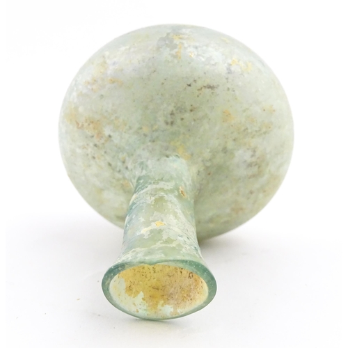 265 - A Roman glass flask with globular body and flared rim. Approx. 2 1/2