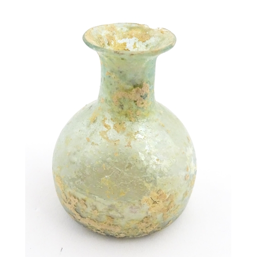 266 - A Roman glass flask with flared rim. Approx. 2 1/4