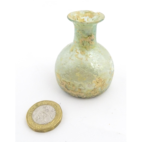 266 - A Roman glass flask with flared rim. Approx. 2 1/4