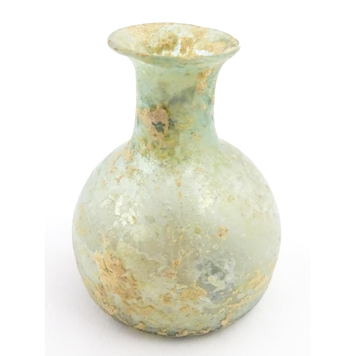 266 - A Roman glass flask with flared rim. Approx. 2 1/4