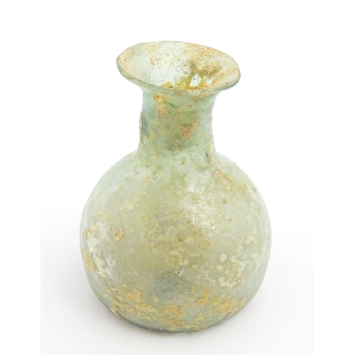 266 - A Roman glass flask with flared rim. Approx. 2 1/4