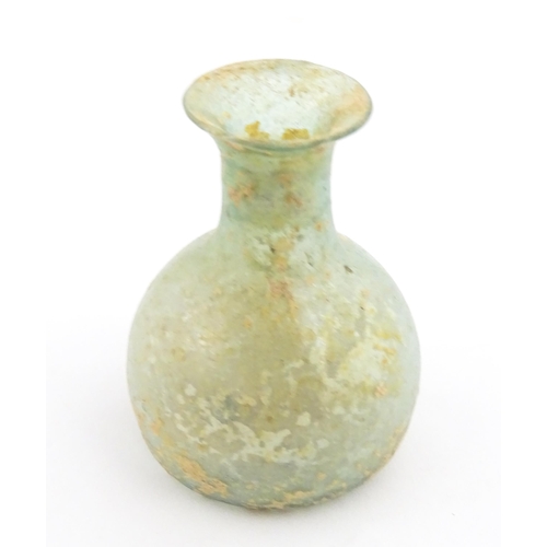 266 - A Roman glass flask with flared rim. Approx. 2 1/4