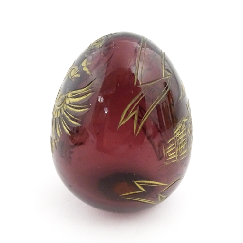 271 - A 20thC Russian glass egg with etched decoration depicting a double headed eagle to one side, and bu... 