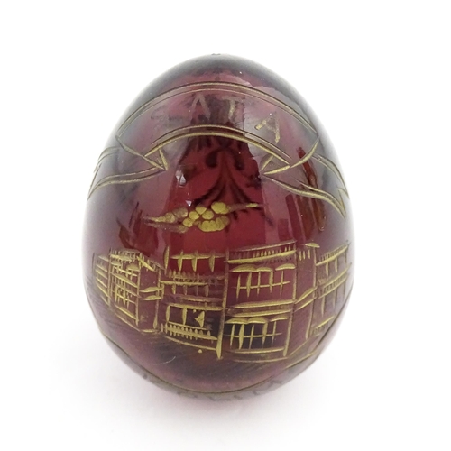 271 - A 20thC Russian glass egg with etched decoration depicting a double headed eagle to one side, and bu... 