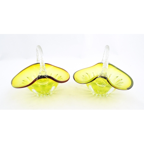 289 - A pair of yellow glass bon bon baskets with clear glass handle and red banded detail. Approx. 5 1/2