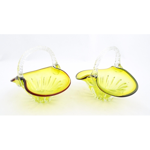 289 - A pair of yellow glass bon bon baskets with clear glass handle and red banded detail. Approx. 5 1/2