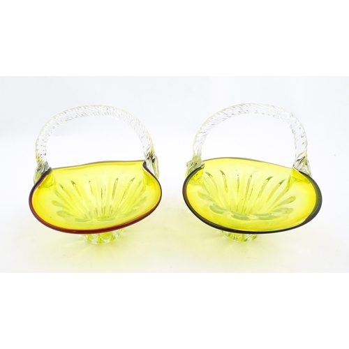 289 - A pair of yellow glass bon bon baskets with clear glass handle and red banded detail. Approx. 5 1/2