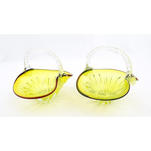 289 - A pair of yellow glass bon bon baskets with clear glass handle and red banded detail. Approx. 5 1/2