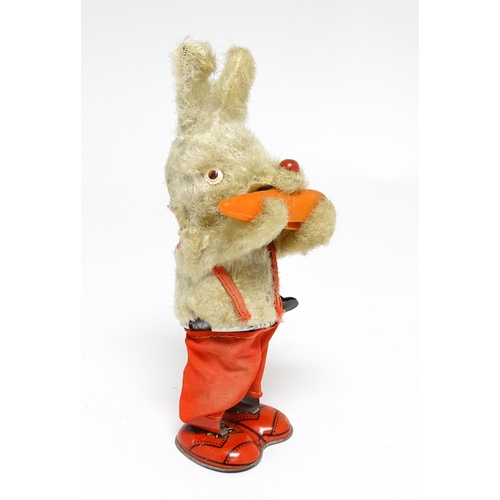 1170 - Toy: A 20thC clockwork / wind up 'Carrot Bunny', a bunny rabbit eating a carrot. Made in Japan. Appr... 