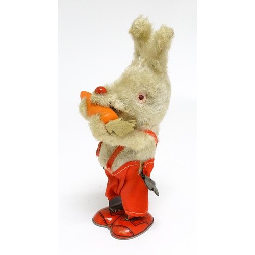 1170 - Toy: A 20thC clockwork / wind up 'Carrot Bunny', a bunny rabbit eating a carrot. Made in Japan. Appr... 