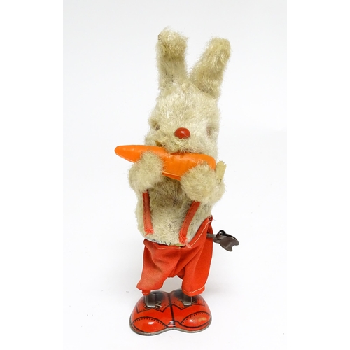 1170 - Toy: A 20thC clockwork / wind up 'Carrot Bunny', a bunny rabbit eating a carrot. Made in Japan. Appr... 