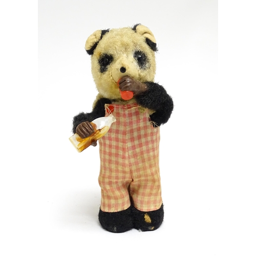 1170A - Toy: A 20thC clockwork / wind up 'Thirsty Bear', a panda bear with bottle and cup. Made in Japan. Ap... 