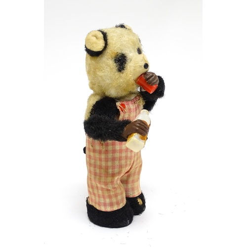 1170A - Toy: A 20thC clockwork / wind up 'Thirsty Bear', a panda bear with bottle and cup. Made in Japan. Ap... 