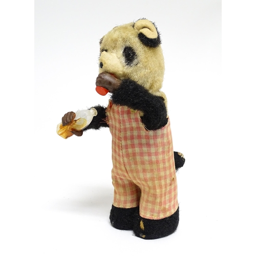 1170A - Toy: A 20thC clockwork / wind up 'Thirsty Bear', a panda bear with bottle and cup. Made in Japan. Ap... 