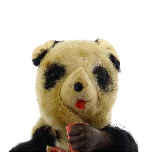 1170A - Toy: A 20thC clockwork / wind up 'Thirsty Bear', a panda bear with bottle and cup. Made in Japan. Ap... 