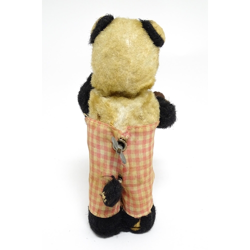 1170A - Toy: A 20thC clockwork / wind up 'Thirsty Bear', a panda bear with bottle and cup. Made in Japan. Ap... 