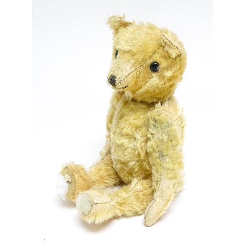 1171 - Toy: A 20thC teddy bear with stitched nose and mouth with articulated limbs. Approx. 13