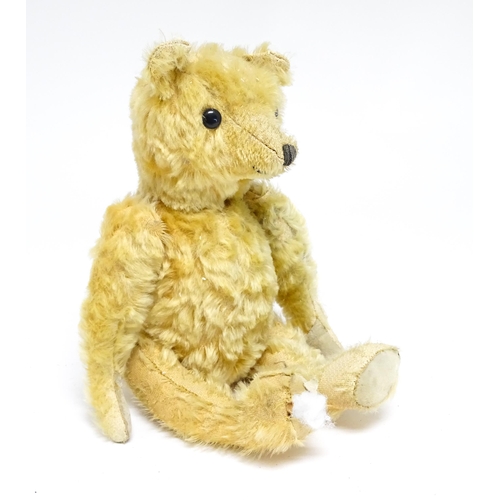 1171 - Toy: A 20thC teddy bear with stitched nose and mouth with articulated limbs. Approx. 13