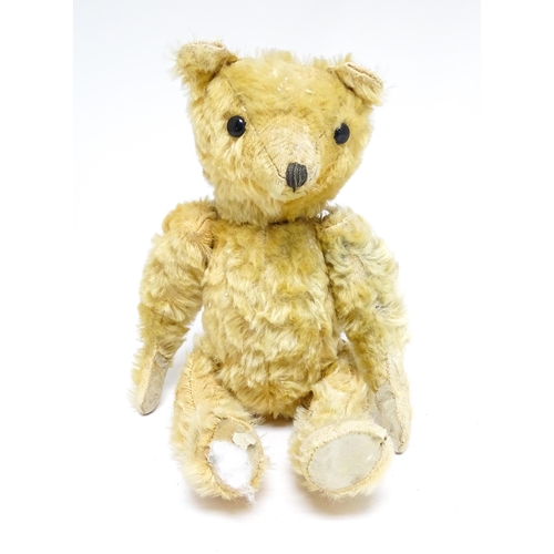 1171 - Toy: A 20thC teddy bear with stitched nose and mouth with articulated limbs. Approx. 13