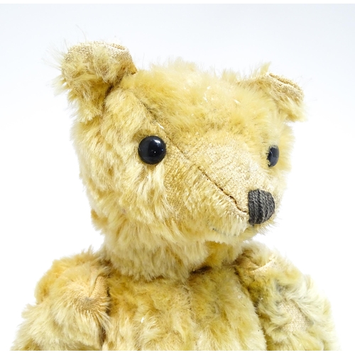 1171 - Toy: A 20thC teddy bear with stitched nose and mouth with articulated limbs. Approx. 13