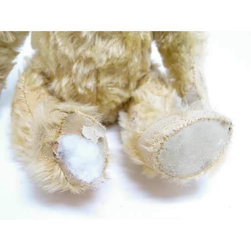 1171 - Toy: A 20thC teddy bear with stitched nose and mouth with articulated limbs. Approx. 13