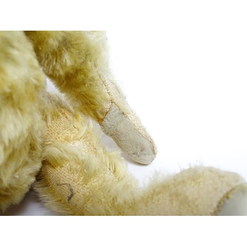 1171 - Toy: A 20thC teddy bear with stitched nose and mouth with articulated limbs. Approx. 13