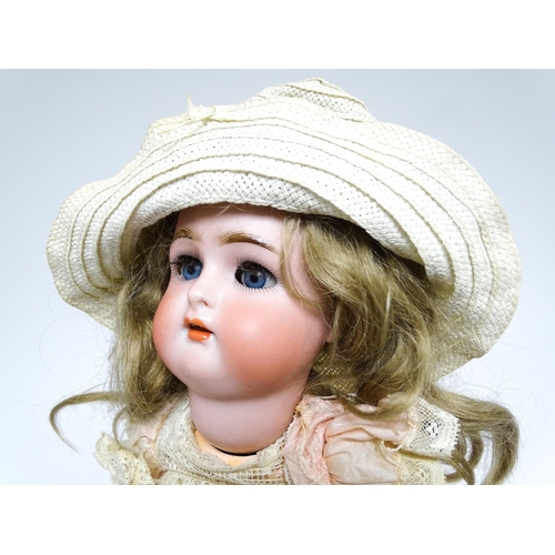 1172 - Toy: A German Kammer & Reinhardt doll with bisque head, blinking eyes, painted lips and eyebrows, wi... 