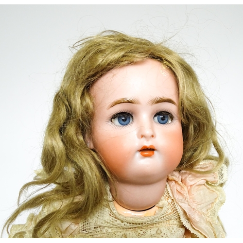 1172 - Toy: A German Kammer & Reinhardt doll with bisque head, blinking eyes, painted lips and eyebrows, wi... 