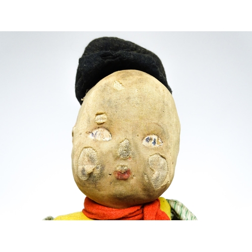 1182 - Toys: Four assorted 20thC toys to include an early 20thC Continental Lenci style felt cloth doll mod... 