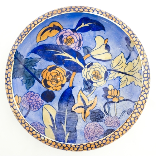 146 - A 20thC charger designed by Charlotte Rhead decorated in the peony flower pattern no. 1432. Probably... 