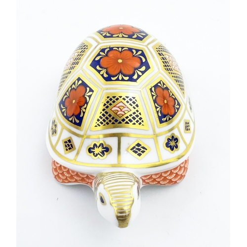 151 - A Royal Crown Derby paperweight modelled as a tortoise. Marked under, with gold stopper. Approx. 4 1... 