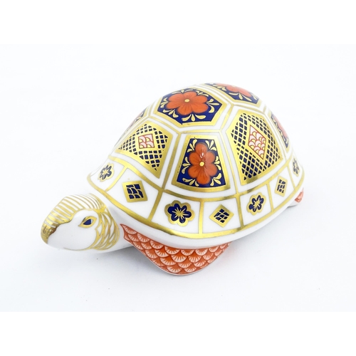 151 - A Royal Crown Derby paperweight modelled as a tortoise. Marked under, with gold stopper. Approx. 4 1... 