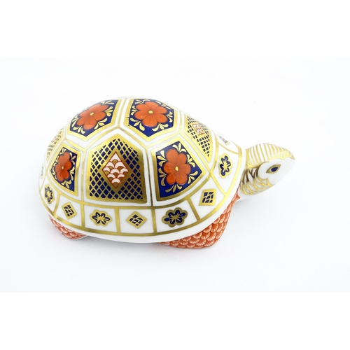 151 - A Royal Crown Derby paperweight modelled as a tortoise. Marked under, with gold stopper. Approx. 4 1... 