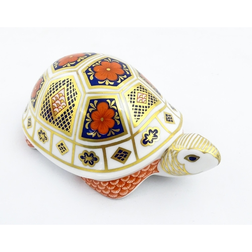 151 - A Royal Crown Derby paperweight modelled as a tortoise. Marked under, with gold stopper. Approx. 4 1... 