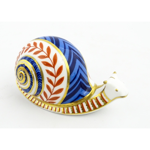 152 - A Royal Crown Derby paperweight modelled as a snail. Marked under, with gold stopper. Approx. 5