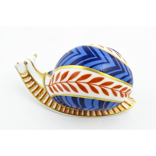 152 - A Royal Crown Derby paperweight modelled as a snail. Marked under, with gold stopper. Approx. 5