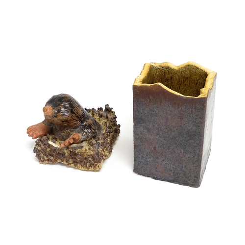 179 - A studio pottery box and cover of rectangular form, the lid surmounted by a model of a mole emerging... 