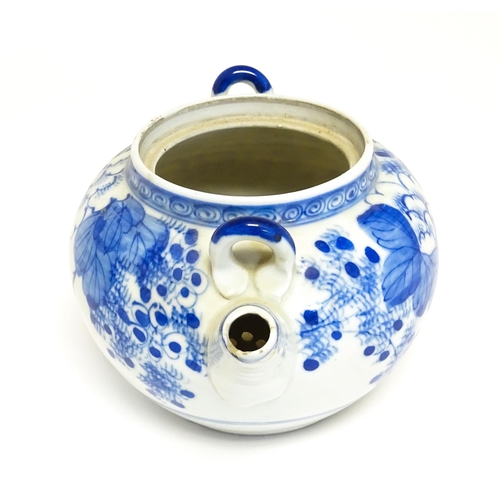 186 - A quantity of Chinese items to include a blue and white teapot with peony flower detail, a blue and ... 