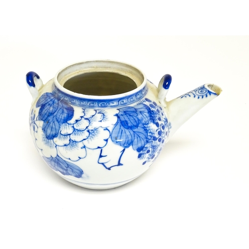 186 - A quantity of Chinese items to include a blue and white teapot with peony flower detail, a blue and ... 