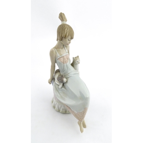 199 - A Lladro model Bedtime Girl with Two Cats, no. 5443. Marked under. Approx. 9 1/2