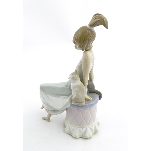 199 - A Lladro model Bedtime Girl with Two Cats, no. 5443. Marked under. Approx. 9 1/2