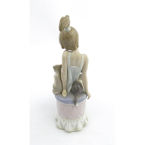 199 - A Lladro model Bedtime Girl with Two Cats, no. 5443. Marked under. Approx. 9 1/2