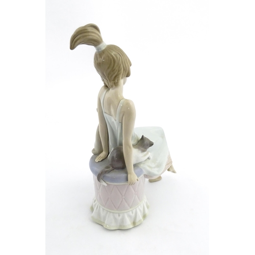 199 - A Lladro model Bedtime Girl with Two Cats, no. 5443. Marked under. Approx. 9 1/2