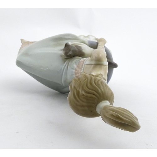 199 - A Lladro model Bedtime Girl with Two Cats, no. 5443. Marked under. Approx. 9 1/2