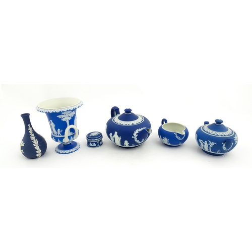 204 - A quantity of Wedgwood dark blue jasperware items with applied white Classical figures and motifs to... 