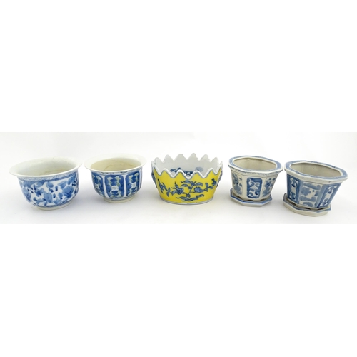 205 - A Chinese yellow ground planter with floral detail. Character marks under. Together with four blue a... 